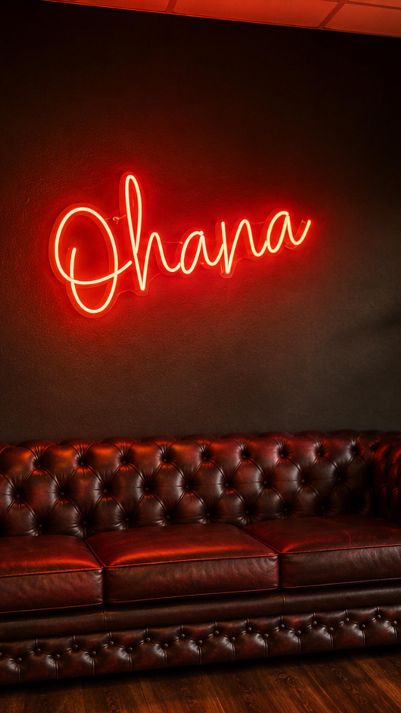 The warm 'Ohana' neon sign glowing above the Chesterfield sofa in the Tanners Lane lounge